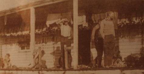 Source: Phyllis Dowling Collection.Rabbit skins drying on verandah of Long Plain hut. Circa 1939